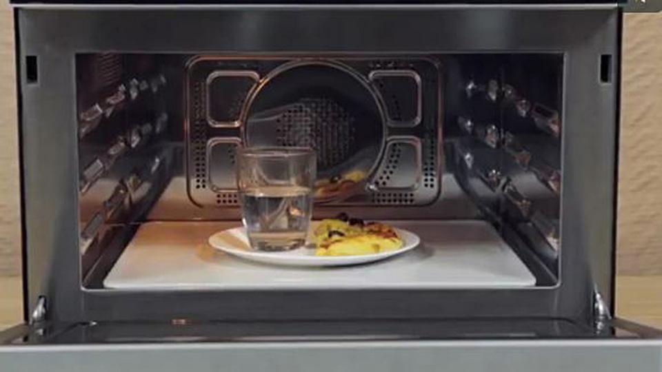 We can put a glass of water in the microwave while heating up the pizza