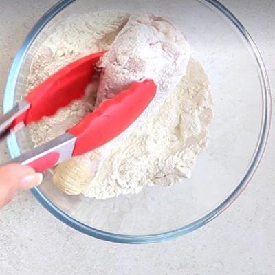 dip the chicken thighs into the bowl of wheat flour