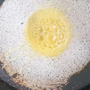 spread butter to cover the surface of the pan
