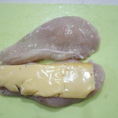 place cheddar on a half of the chicken breast