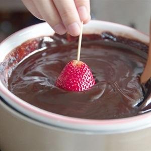 dip strawberry into the mixture of chocolate