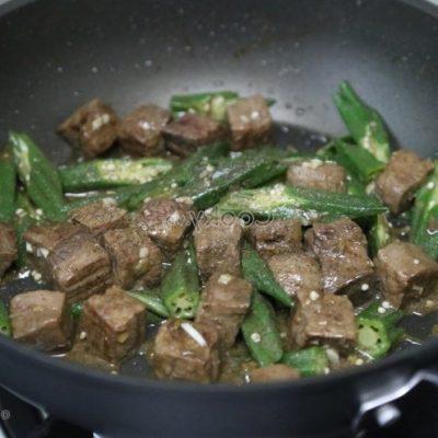 add okra and continue to stir-fry