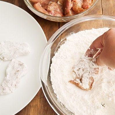 dip chicken meat into the bowl of flour