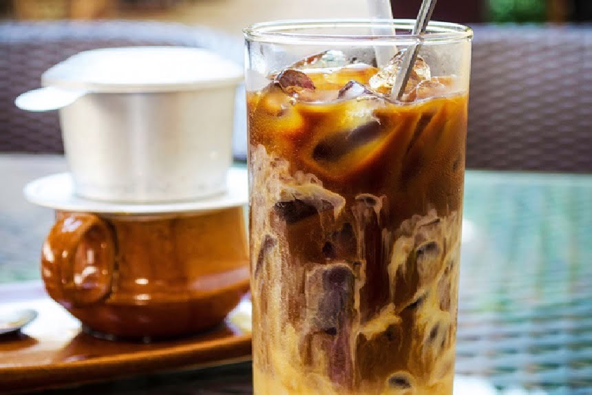 The attractive golden brown color of an iced coffee cup with milk